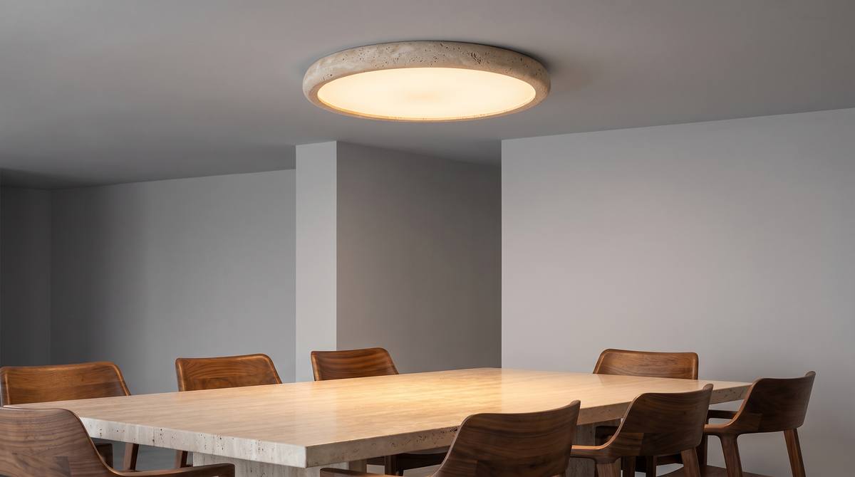 Travertine flush ceiling light with a stone rim and soft white glow over a dining table