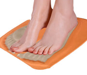 Feet resting on the EMS foot massager mat